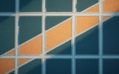 Overhead view of a grid of white paved paths on a deep navy lawn with a worn orange shortcut cutting diagonally across it